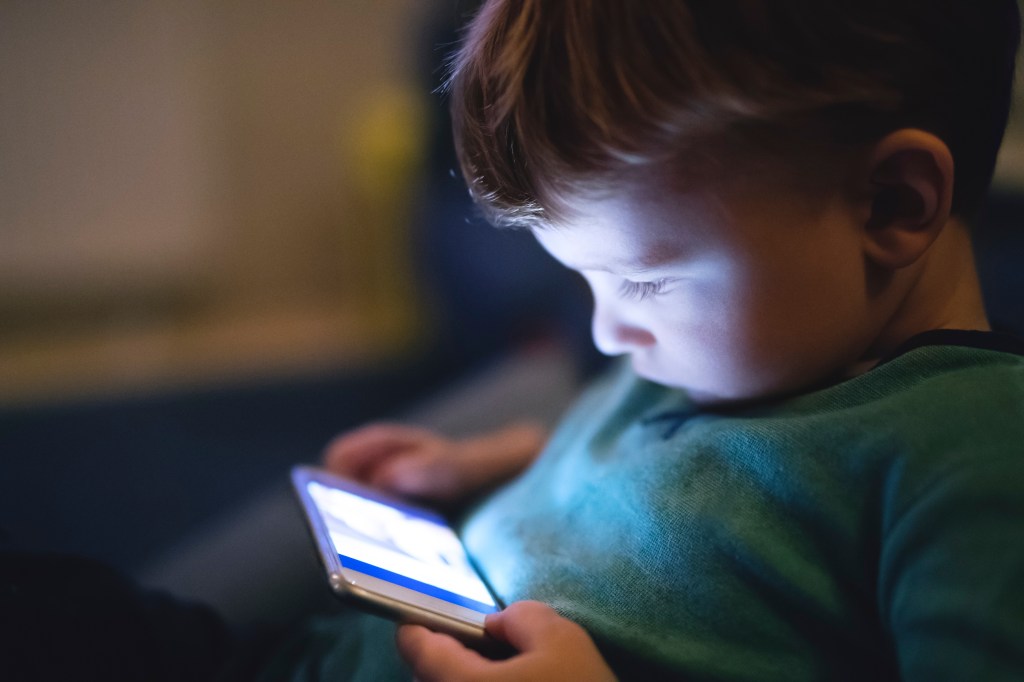 A child on a smartphone.