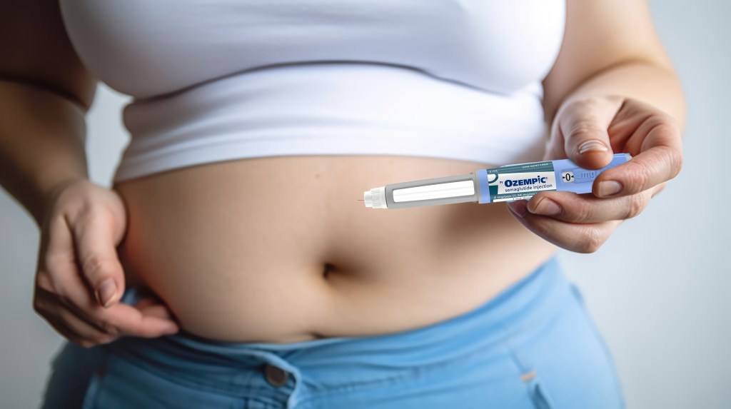 Woman holding an Ozempic semaglutide diabetes and weight loss injection pen next to her stomach