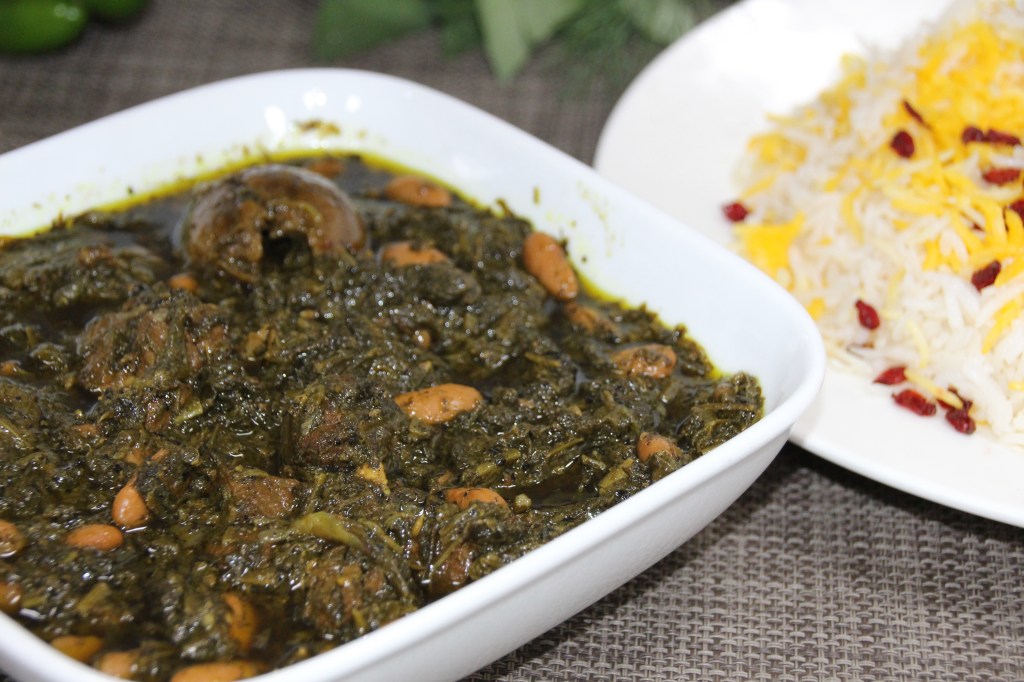 Ghormeh zabzi is a Persian stew made with beef, parsley, onion, cilantro, genugreen, beans, turmeric and lime.