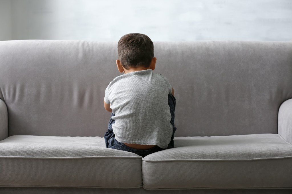 "By identifying DDX53 as a key player, particularly in men, we can better understand the biological mechanisms at play and improve diagnostic accuracy for individuals and their families." said senior study author Stephen Scherer. Here, a little boy sits alone on a sofa.