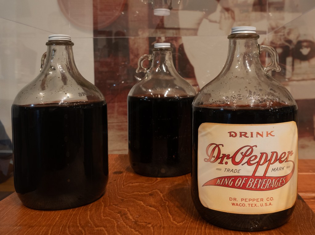 Vintage bottles of Dr. Pepper exhibited at the Museum Dr. Pepper in Waco, Texas with a labeled bottle