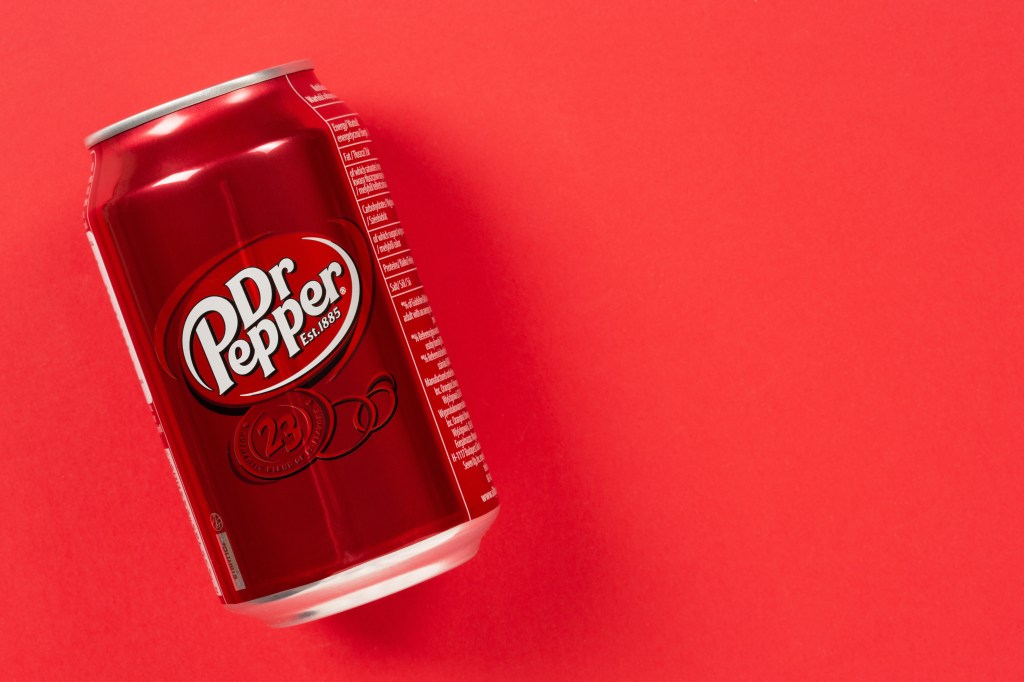 Can of Dr Pepper drink on a red background