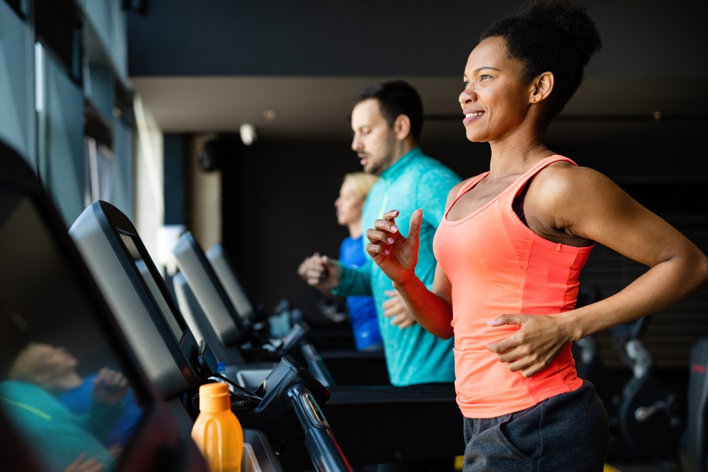 An exercise program should include cardiovascular exercise, strength training, flexibility work and stability exercises. Here, a woman runs on a treadmill.