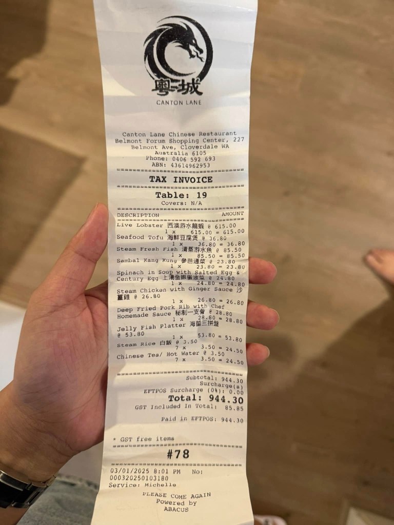 A hand holding a bill from a Perth restaurant that paid $615 for live lobster