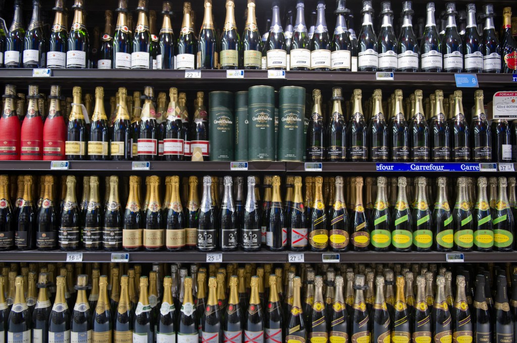 A shelf of champagne bottles in a supermarket near Paris, showing a drop in sales