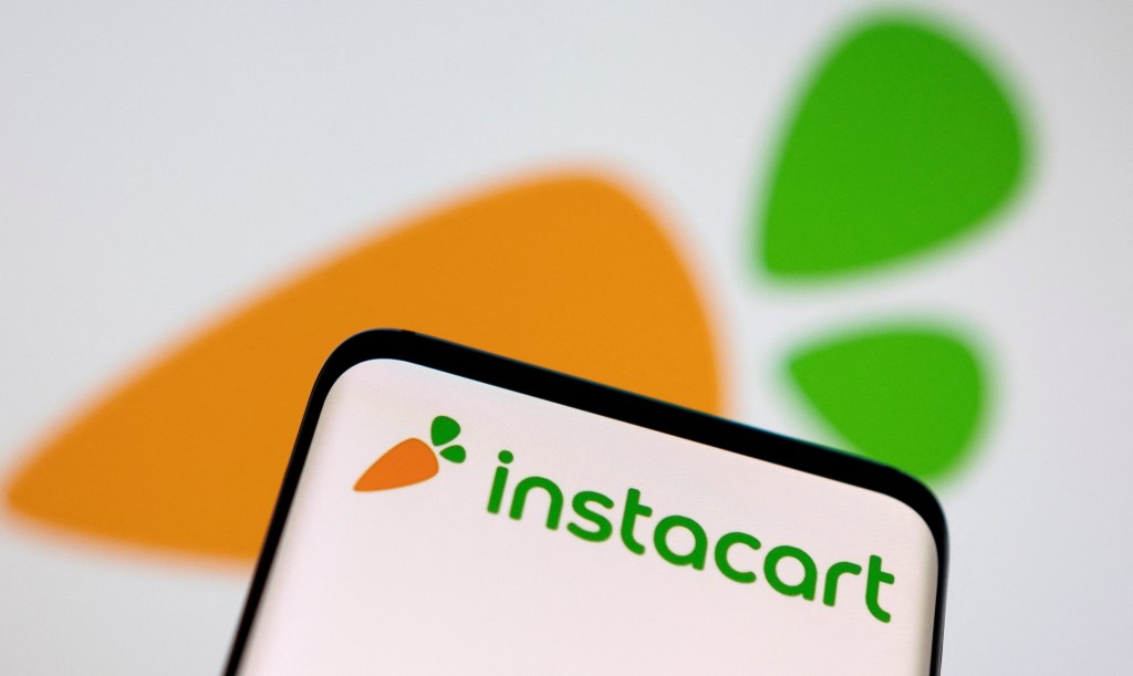 The smartphone with the Instacart logo displayed is seen in this illustration