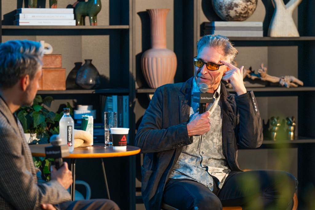 Biohacker Dave Asprey sitting in a chair with a microphone