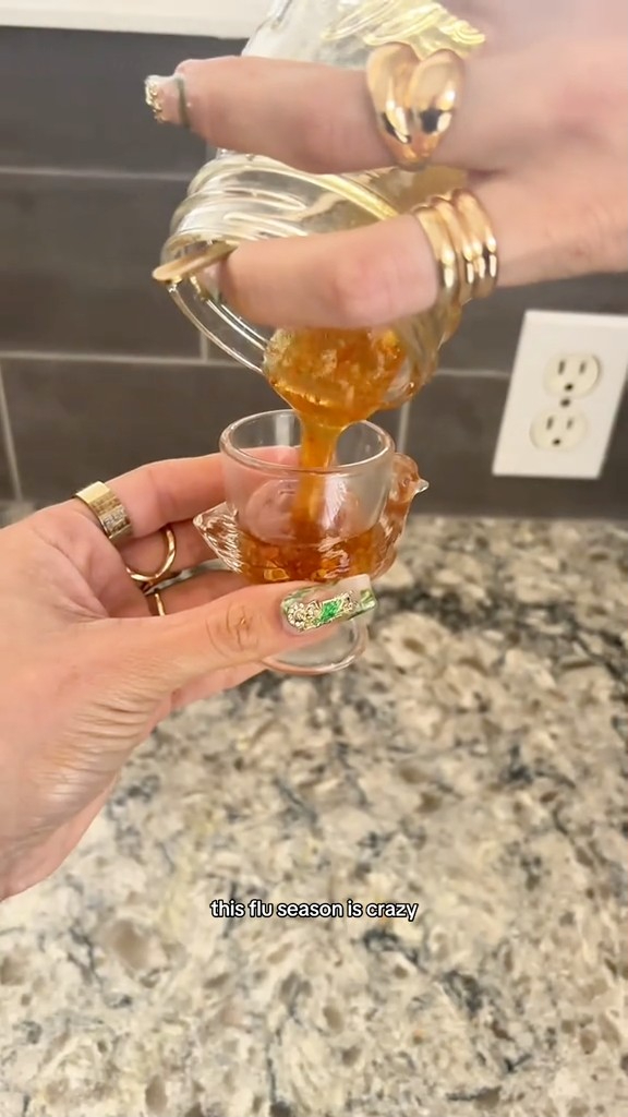 Lo Reyez pours a flu bomb mixture into a glass